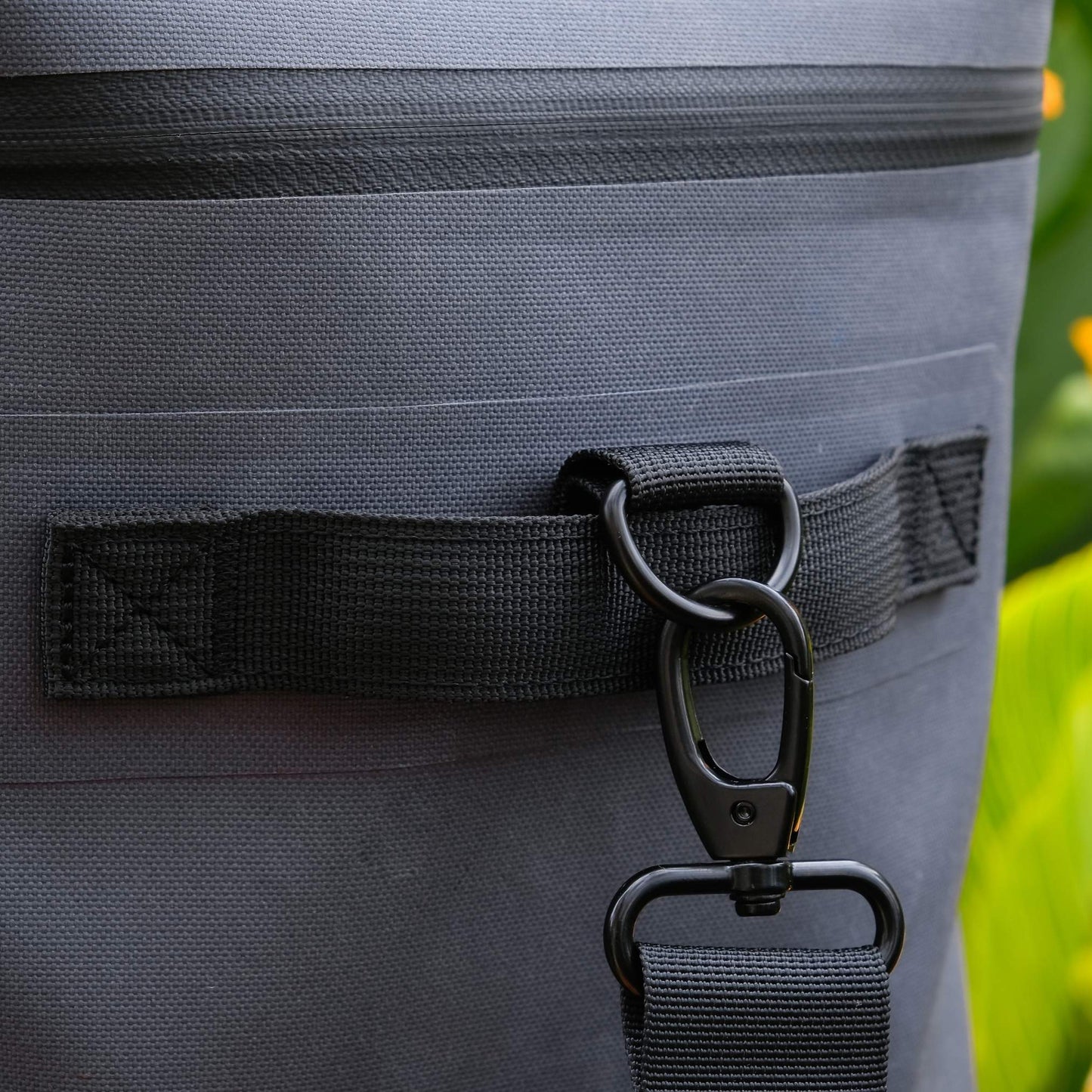 Close up of metal buckle on NIPPY Cooler showing the quality of the hardware and carrying straps on the bag. 