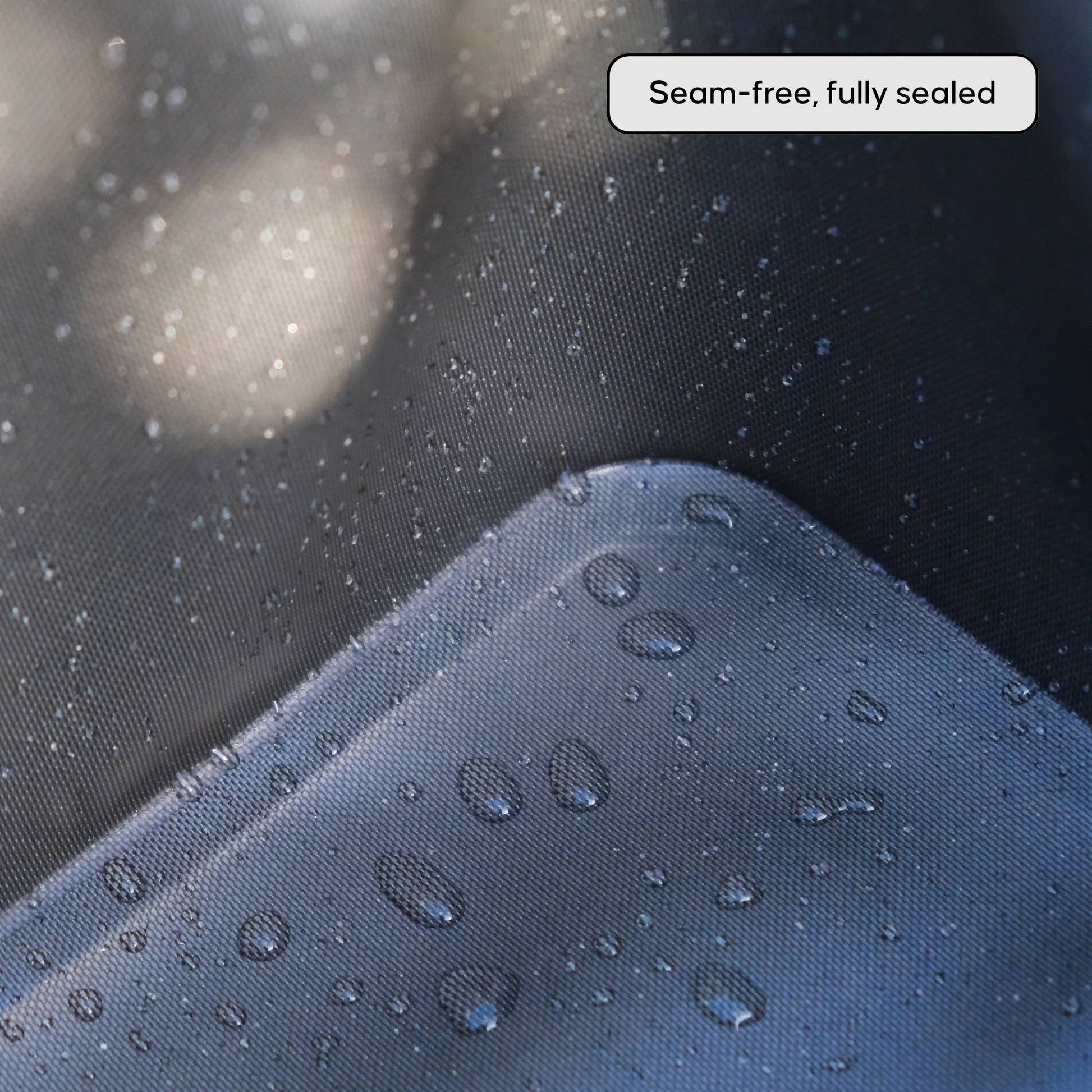 Close-up of a inside material of NIPPY Cooler to show water-resistant surface with water droplets, labeled 'Seam-free, fully sealed'.